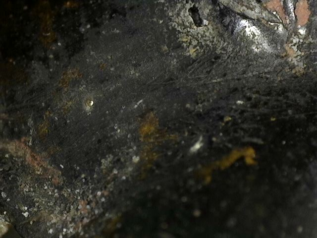 Microscoopdetail van rituele contactslijtage op antiek bronzen Ganesha