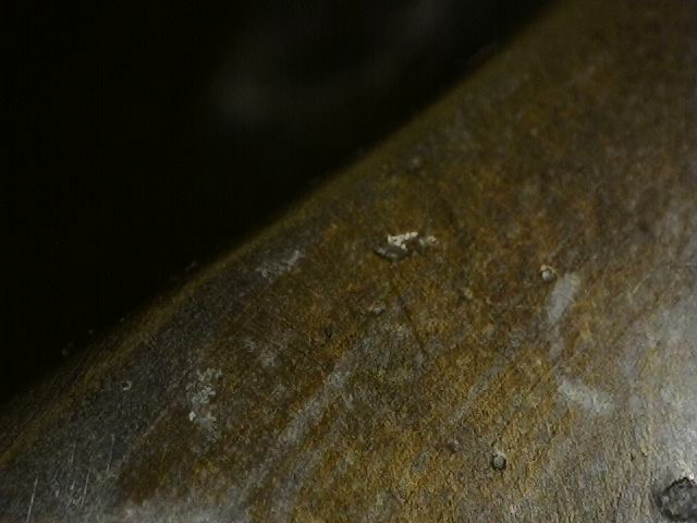 Detail van minerale insluitingen en patinalagen op pre-industrieel gegoten Vishnu borstbeeld